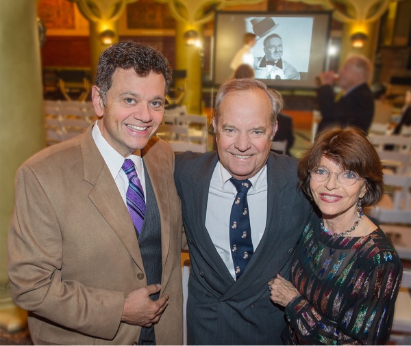 Dana, Ron and Harriet standing together in front of projected image.
