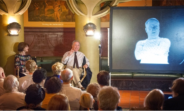 Harriet with Dick commenting before an audience.