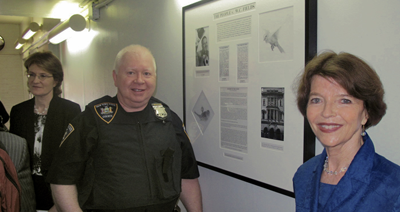 Judge Felicia Mennin with Court Officer and Dr. Harriet Fields standing in front of tribute