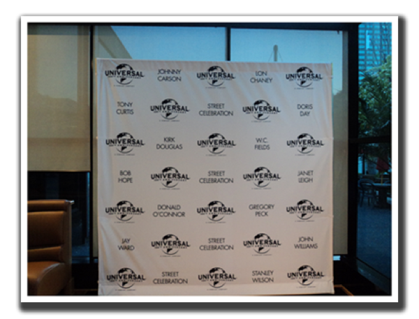 Universal Studios Street Celebration banner in bus shelter.